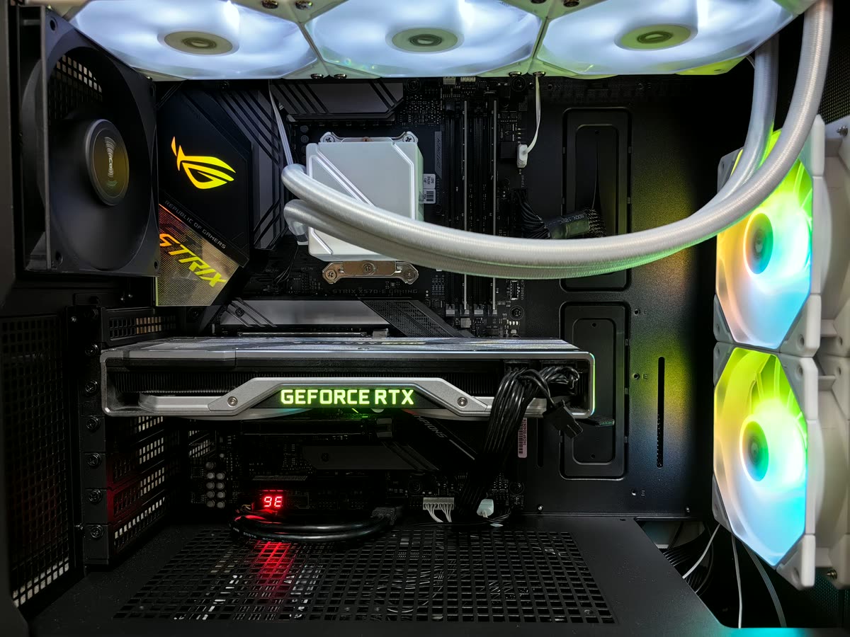 A GeForce RTX graphics card inside a lit gaming PC